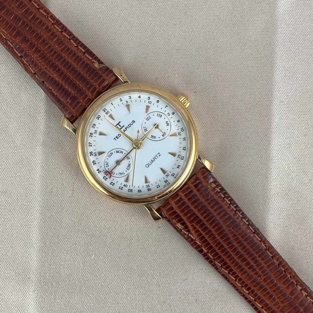 Ted Lapidus Gold Tone Case Quartz Analog UNISEX Watch 4 Hand White Enamel Dial